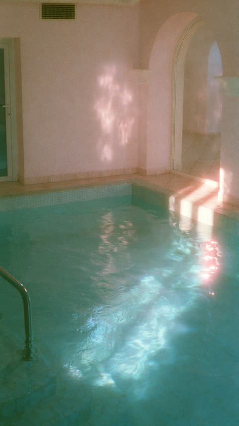Quiet Indoor Pool: swimming pool, pastel — AI-generated Photorealistic image made with Midjourney